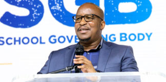 Gauteng education MEC Matome Chiloane with sign language Tsholofelo Segatswi delivers the keynote address at school governing inauguration ceremony in Randburg