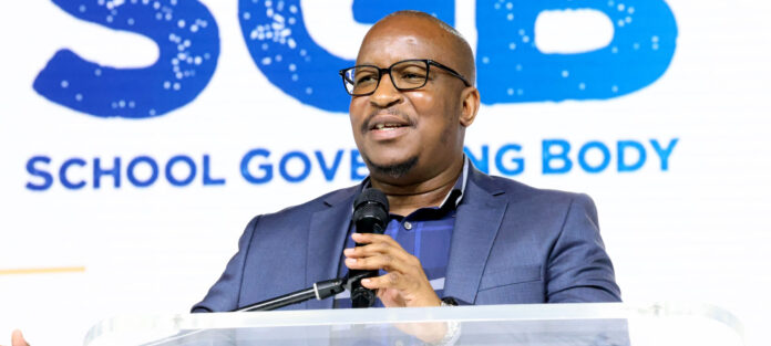 Gauteng education MEC Matome Chiloane with sign language Tsholofelo Segatswi delivers the keynote address at school governing inauguration ceremony in Randburg