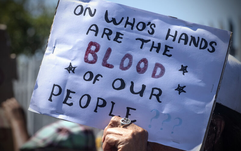 MITCHELL'S PLAIN, SOUTH AFRICA - JANUARY 25: Community members during a protest outside Mitchells Plain Police Station on January 25, 2024 in Mitchell's Plain, South Africa. It is alleged that 15 guns and 8 imitation guns were stolen or went missing from the SAPS in November 2023. (Photo by Gallo Images/Brenton Geach)