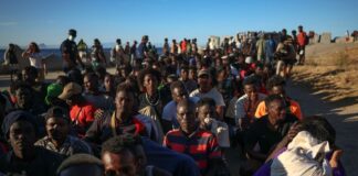 Migrants receive food and beverages from the Red Cross in Ceuta, Spain.