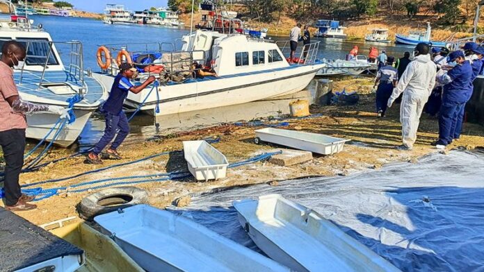 Rescue and recovery personnel on the shoreline of Lake Kariba during an operation to recover victims from a capsized ferry.