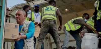 UNICEF staff and airport workers receive medical supplies at Bunia National Airport in Democratic Republic of Congo.