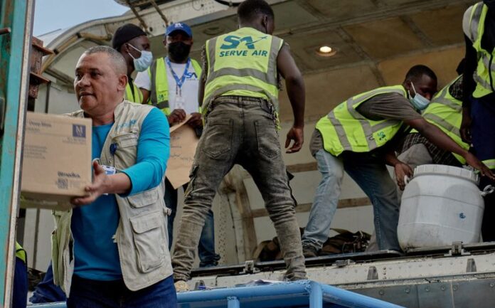 UNICEF staff and airport workers receive medical supplies at Bunia National Airport in Democratic Republic of Congo.