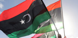 FILE PHOTO: People wave Libyan flags during a demonstration in Benghazi