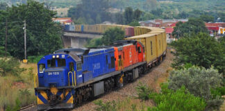 Train on a railway line representing South African freight rail infrastructure and logistics network.