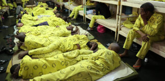 Awaiting-trial prisoners lying on beds in an overcrowded cell at Westville Prison in Durban