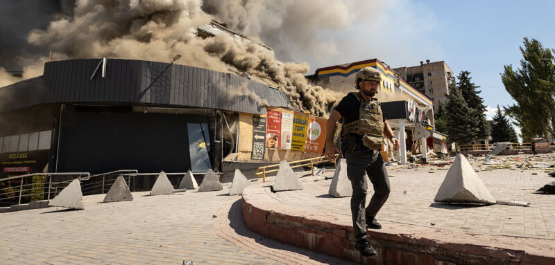 Emergency worker stands near a damaged supermarket following a Russian airstrike in Kramatorsk, Ukraine