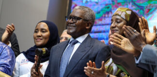 Aliko Dangote holding a gavel at the Dangote Refinery IPO opening in Lagos.