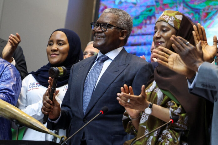 Aliko Dangote holding a gavel at the Dangote Refinery IPO opening in Lagos.