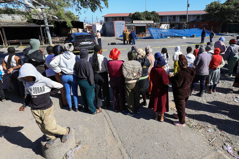 South Africa police hunt suspects after 27 killed in two separate shootings People gathered at a shooting site in Lwandle, Western Cape.