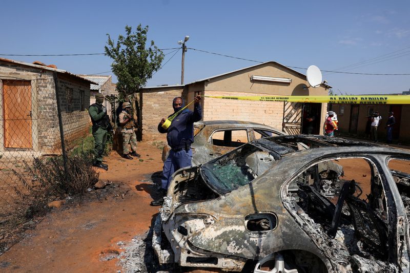 Death toll in Wedela tavern shooting rises to 18 Emergency personnel cordon off an area with burnt vehicles at a tavern shooting site in Wedela township.