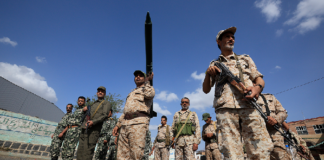 Houthi fighters gather during a campaign to mobilize more fighters