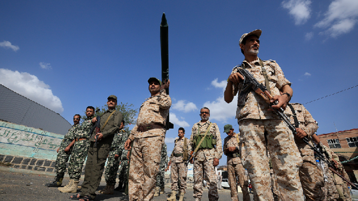 Houthi fighters gather during a campaign to mobilize more fighters