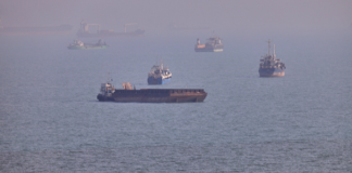 Commercial vessels seen anchored in the Strait of Hormuz off Bandar Abbas, Iran, August 5, 2026. /VCG