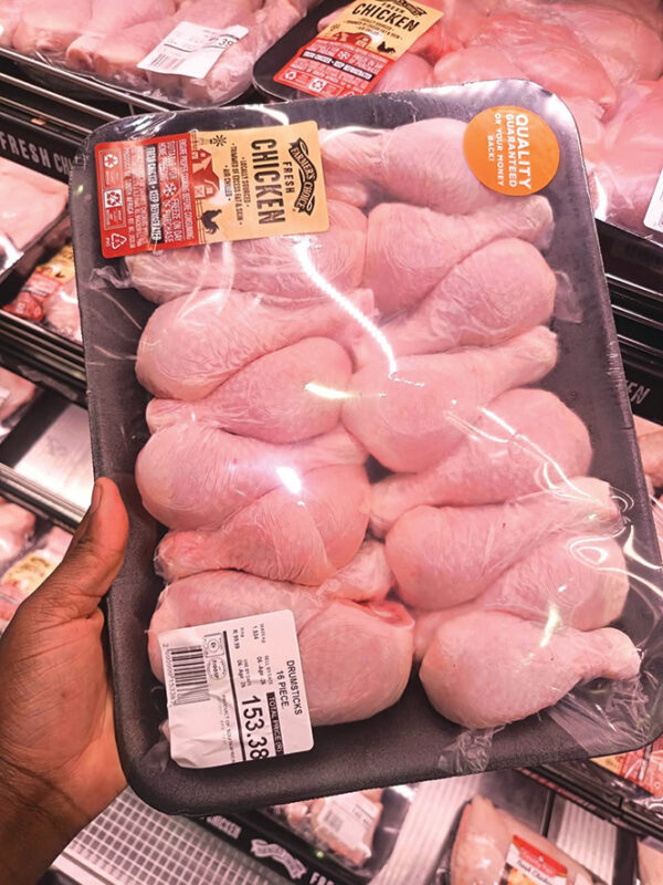 Packaged chicken portions displayed in a retail store representing rising staple food costs in South Africa.