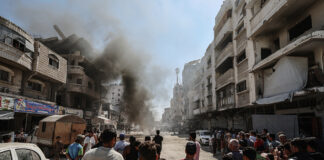 Burning vehicle on a street following an Israeli air strike in Gaza City's Tel al-Hawa neighborhood