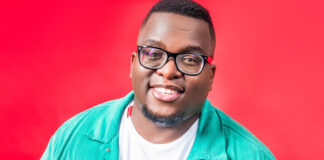 Media personality Sol Phenduka posing in a black shirt against a grey backdrop