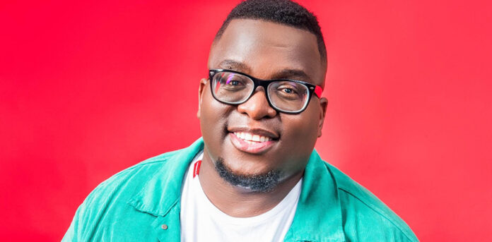 Media personality Sol Phenduka posing in a black shirt against a grey backdrop