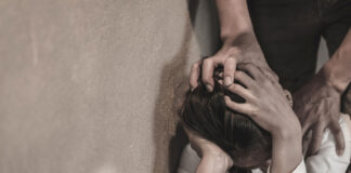 A woman reflecting on domestic abuse and police response failures in South Africa