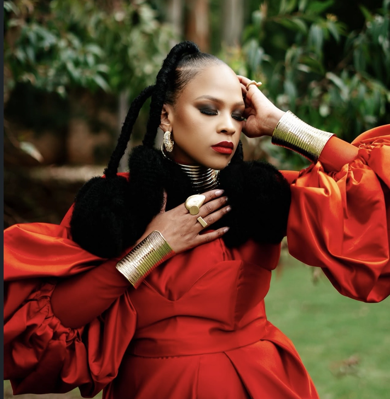 Pilani Bubu in a red dress