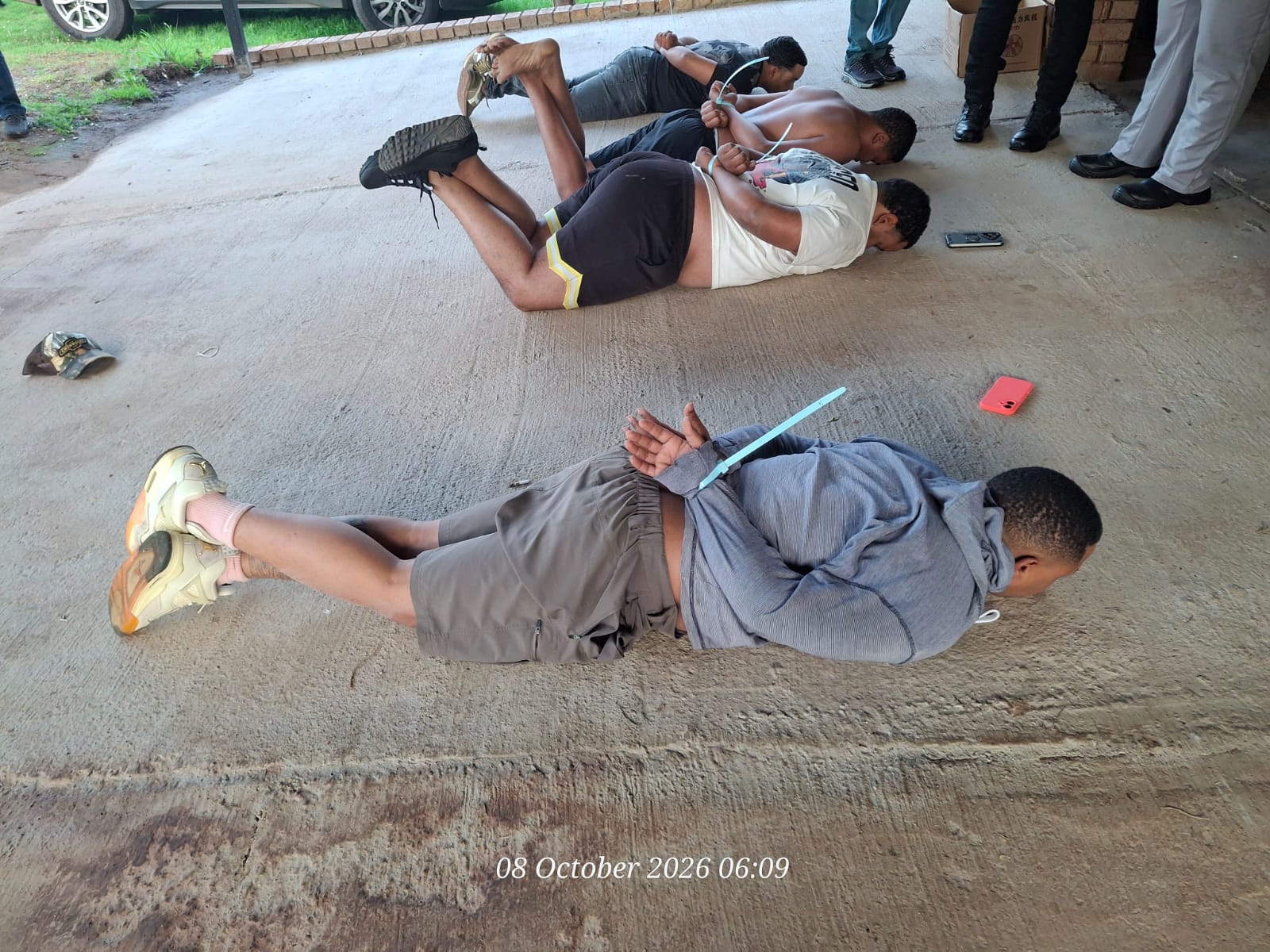 SAPS busts multi-million rand drug lab in Krugersdorp raid Arrested suspects handcuffed on the floor.